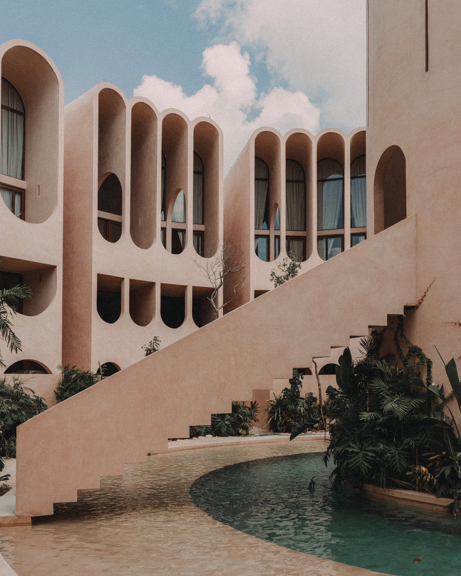 Exterior facade of BABEL showing minimalist geometry and light-textured concrete under natural light
