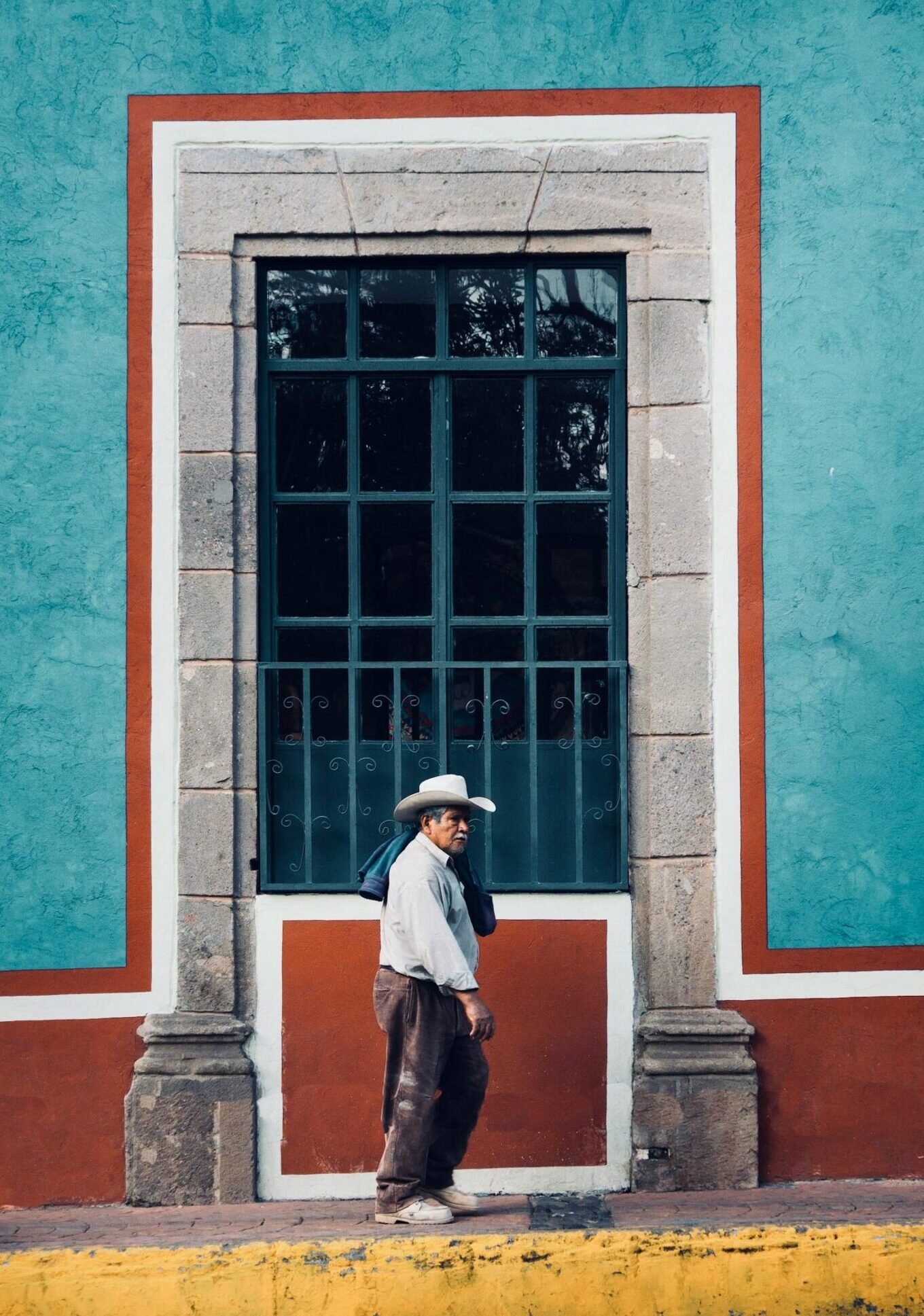 Colorful street architecture in Mexico City with local pedestrians